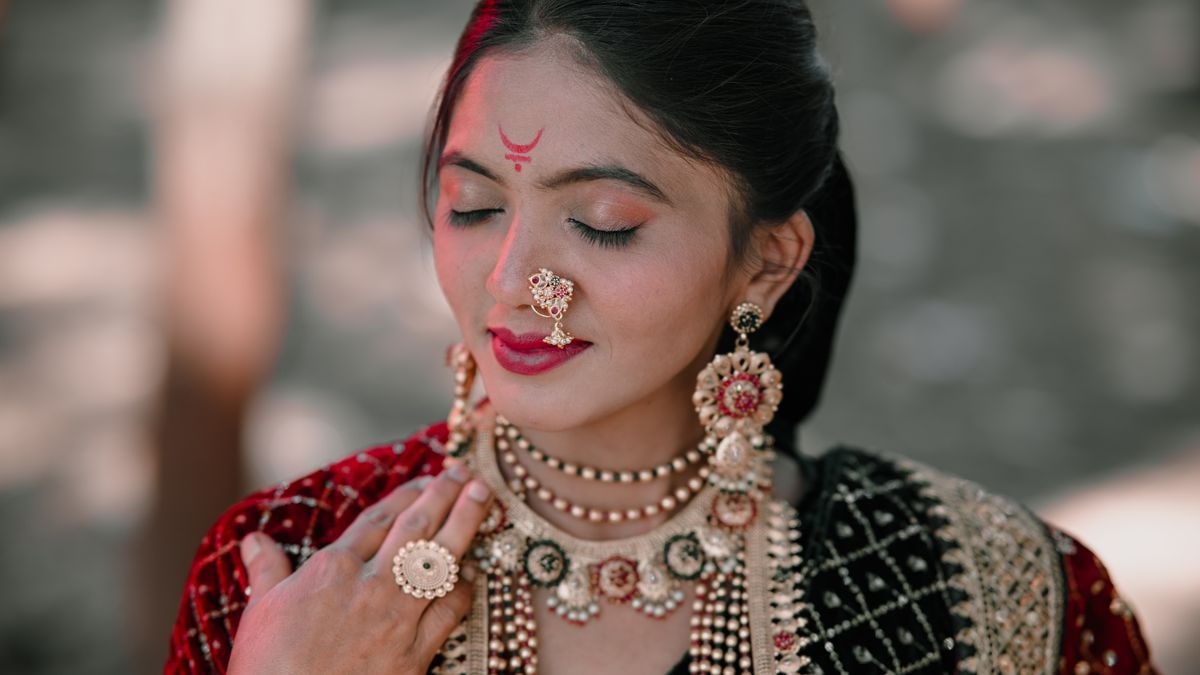 Close-up of a woman wearing traditional Indian attire and intricate jewelry, exuding elegance and grace.